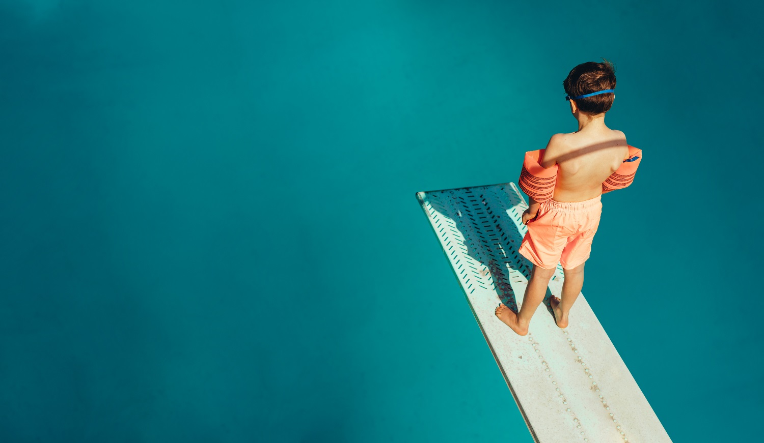 Top,View,Of,Boy,Standing,On,Spring,Board,Learning,To
